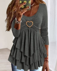 Långa ärmard topp med rund hals och hjärtknapp