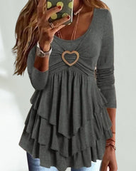 Långa ärmard topp med rund hals och hjärtknapp