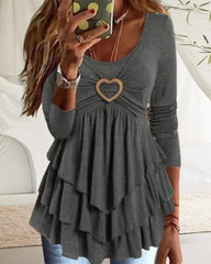 Långa ärmard topp med rund hals och hjärtknapp