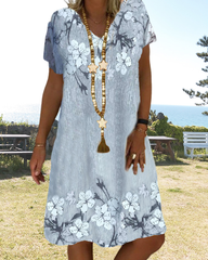 V-ringad avslappnad klänning i blommönster med kort ärm