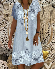 V-ringad avslappnad klänning i blommönster med kort ärm