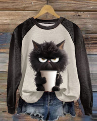 Lös sweatshirt med kattmotiv och färgblock