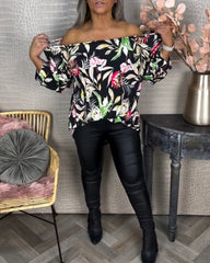 Blus med tryck och en axel