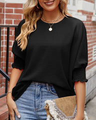 Enfärgad topp med rund hals och halvärm