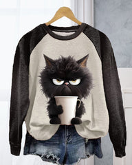 Lös sweatshirt med kattmotiv och färgblock